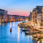 gondolier-heads-into-the-sunset-along-venice-s-grand-canal--sunset--1062428612-261501b5a5f44ffc95f012f908750ad4
